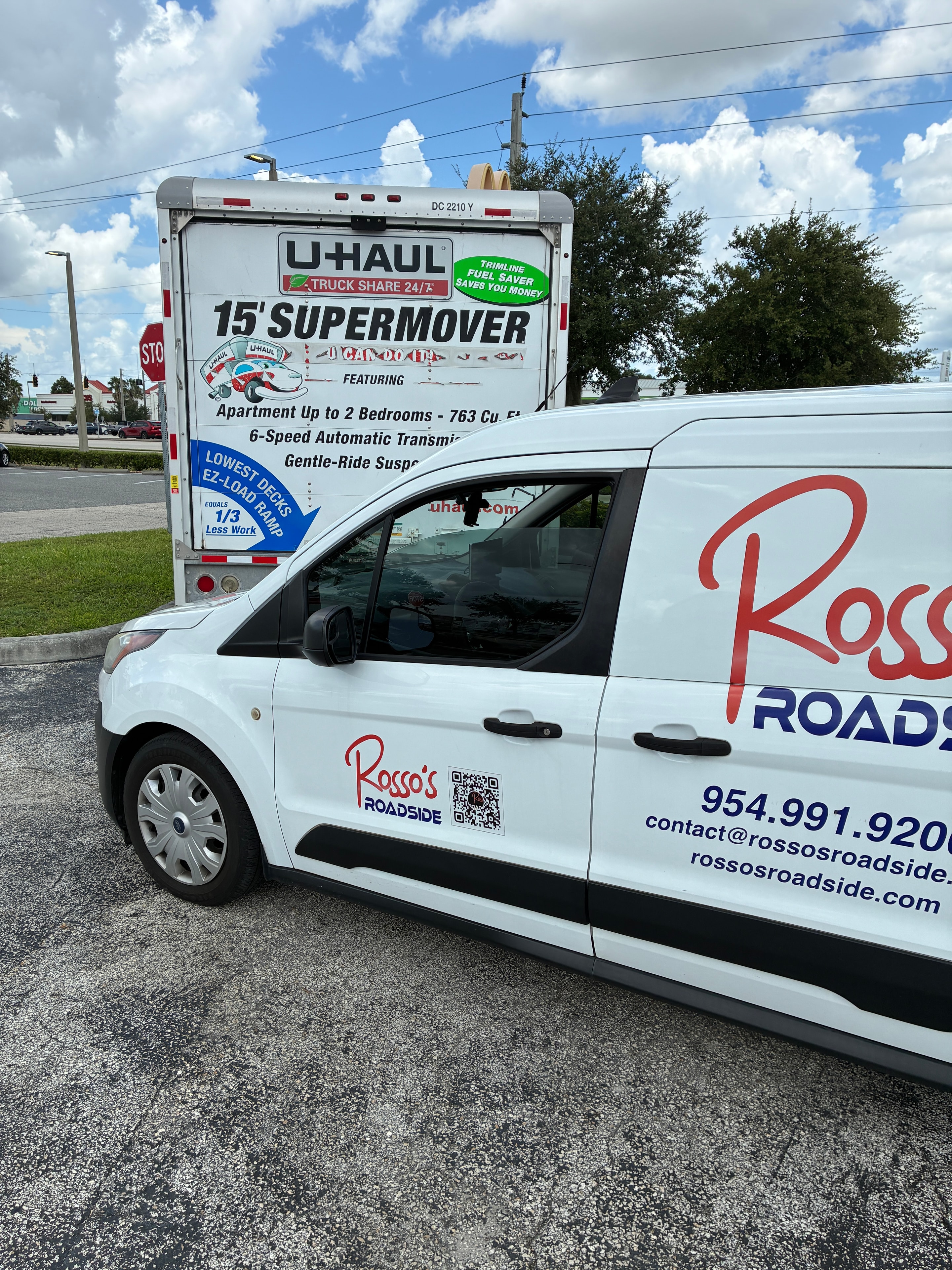 White service van parked near U-Haul truck